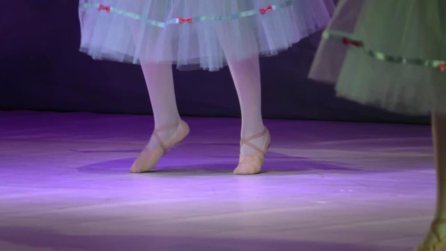 little child girl dreams of becoming ballerina in a pink tutu skirt. Slow motion
