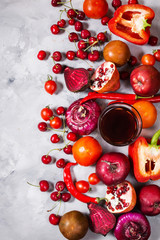 Raw red organic vegetables with fresh ingredients for healthily cooking on concrete background