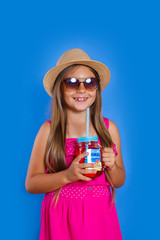 Pretty little girl with hat and sunglasses with summer lemonade. Summer vacation and travel concept