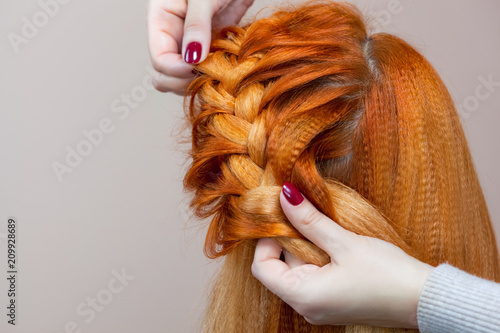 Beautiful Girl With Red Hair Hairdresser Weaves A Braid Close Up