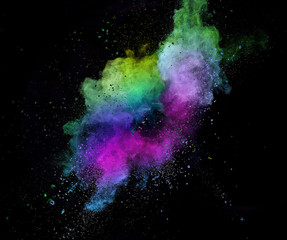 Colored powder explosion isolated on black background.