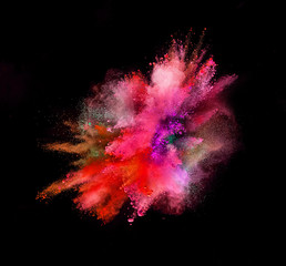 Colored powder explosion isolated on black background.