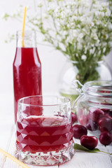 glass with cherry compote.Cherry drink. Fresh cherry cocktail. Fresh summer cocktail with cherry