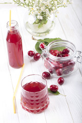 glass with cherry compote.Cherry drink. Fresh cherry cocktail. Fresh summer cocktail with cherry