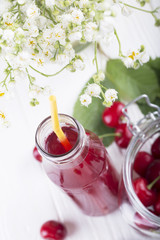 glass with cherry compote.Cherry drink. Fresh cherry cocktail. Fresh summer cocktail with cherry