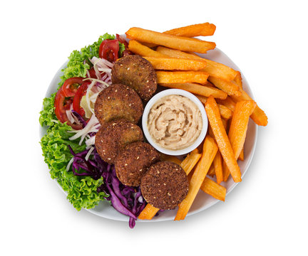 Falafel plate with fresh vegetables, hummus and french fries.