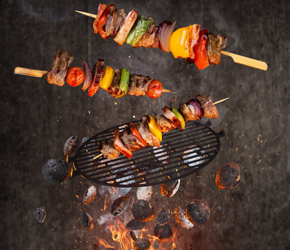 Hot briquettes, cast iron grate and tasty skewers flying in the air.