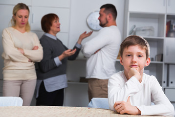 Fototapeta na wymiar Sad boy during parents quarrel