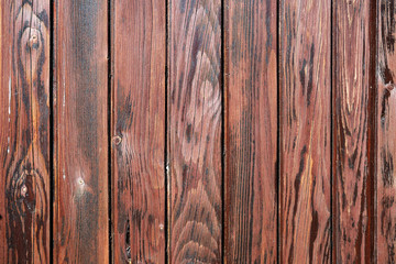 Weathered deep-brown painted wooden board texture