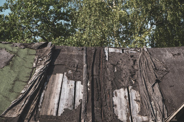 A dilapidated, collapsing village roof.