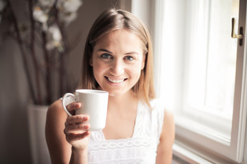Happy girl holding a cup