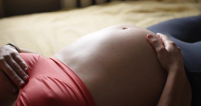 Side view of baby moves inside pregnant mom