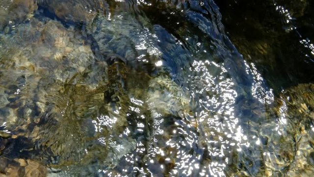 Clean water waving over mountain stones. Val di Mello, Italy. June 2018