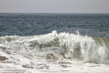 Large powerful wave crashing in the ocean 