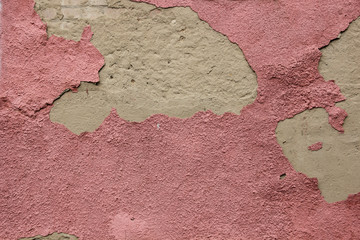 Peeling Burgundy plaster on the wall, background