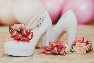 Bride white shoes with flowers on wedding day