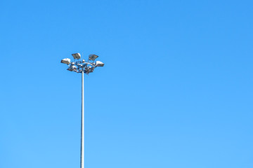 High street lamps against the blue sky.