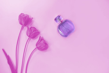 bottle with liquid cosmetic. flowers tulips. toned. concept of beauty.
