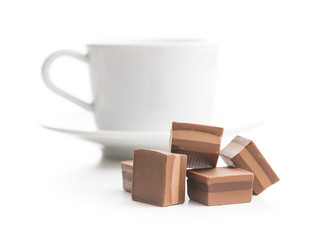 Sweet nougat pralines and coffee cup.