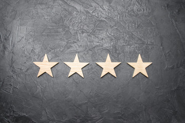 four stars on a dark background. The concept of rating and evaluation. The rating of the hotel,...