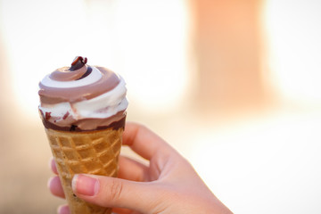 Ice cream cone, chocolate ice cream on blurred background, milk dessert on summer vacation, blank for designer, copy space, milk product