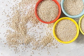 organic quinua cereal in color bowl on white background