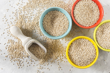 organic quinua cereal in color bowl on white background