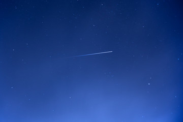 Vanishing International Space Station ISS trail crossing sky with stars - Powered by Adobe
