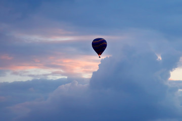 balloon with people flying in the colored sky