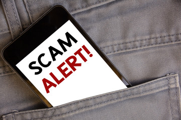 Handwriting text writing Scam Alert Motivational Call. Concept meaning Safety warning to avoid fraud or virus attacksConcept on cell phone into jean pocket white screen black and red letters. - obrazy, fototapety, plakaty