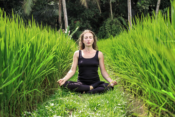 Young woman practicing yoga during luxury yoga retreat in Asia, Bali, meditation, relaxation,...
