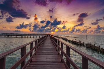 Fototapeta premium The red bridge and sun up in cloud blue sky back ground. bridge cross sea.Thailand landscape .