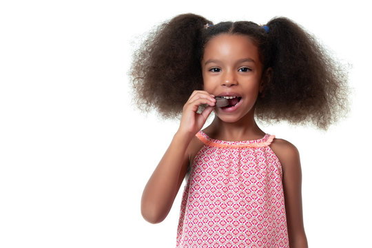 Cute African American Girl Eating A Chocolate Cookie