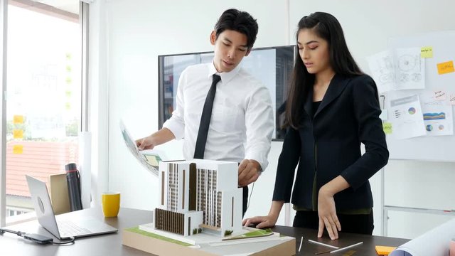 People discuss about building project. People working with serious emotion.