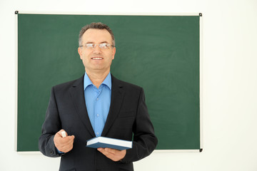 Portrait of male teacher in classroom