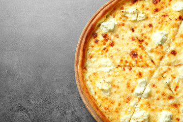Tasty hot cheese pizza on grey background