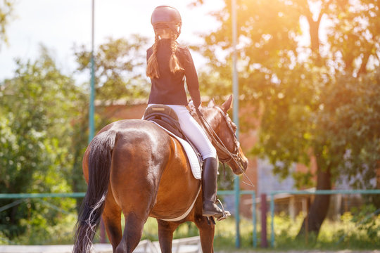 Young girl riding horse on equestrian competition. Equestrian dressage sport background with copy space