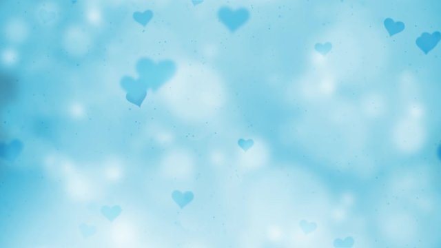 Blue hearts flying around on blurry silver blue colored bokeh background. 