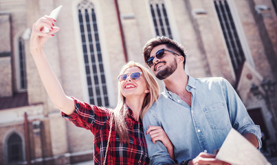 Young smiling couple taking a selfie with mobile phone. Love and tenderness. Dating, lifestyle concept