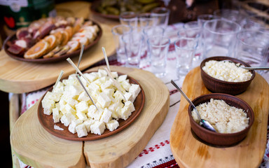 Feta cheese cubes and parsley on a wooden table