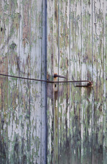 Architecture: Old garage door with rusty handle and peeling paint in Eastern Germany