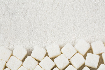 Refined white sugar powder and cubes. Wooden background