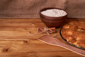 apricot pie and a bowl with flour and other ingredients and tools table