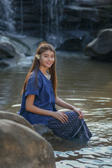 Beautiful women wearing traditional dress in the mountain waterfall
