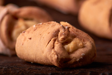 Cookies with Cottage cheese baked in oven, on wooden table and black background. Close up, selective focus. Concept of homemade food