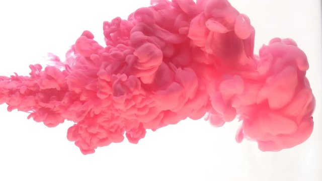Pink ink dropped in water on white background
