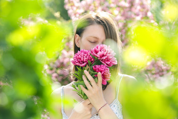 Fototapeta premium Woman with bouquet of peonies