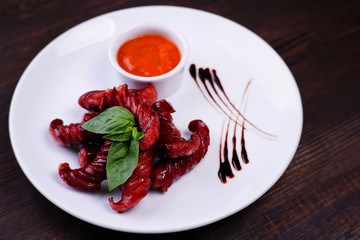 Appetizing beer snacks. Delicious roasted sausages, served with spicy tomato sauce. Oktoberfest food, German cuisine, pub concept
