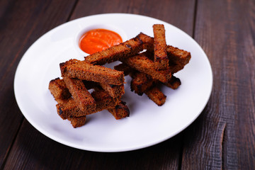 Appetizing beer snacks. Crunchy rye bread toasts, served with spicy tomato sauce. Oktoberfest food, pub concept