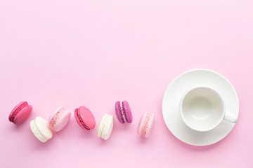Fototapeta na wymiar Colorful cake macaron or macaroon isolated over pastel pink background. Top view
